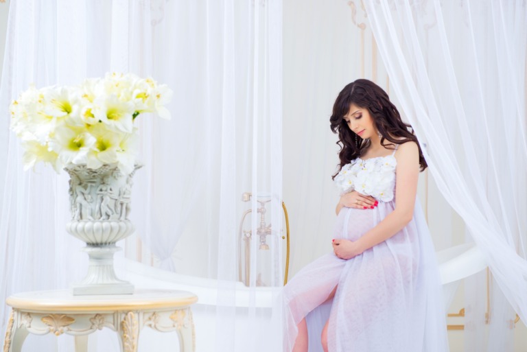 gentle-pregnancy-beautiful-pregnant-light-white-dress-with-orchids